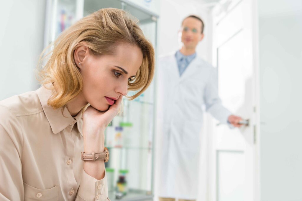 Woman experiencing tooth pain at a dental clinic